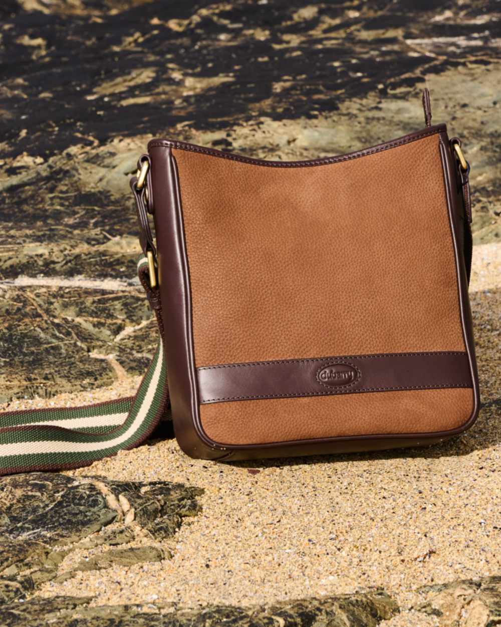 Walnut coloured Dubarry Tullyfern Suede And Leather Handbag on rock background 