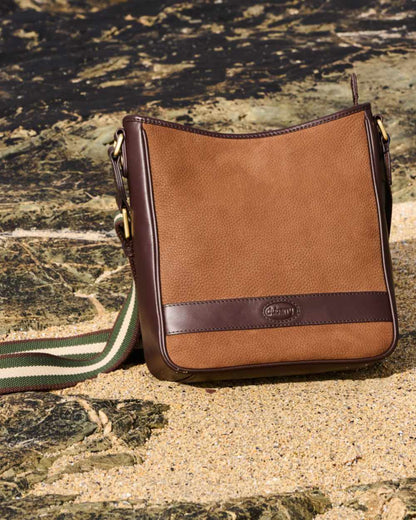 Walnut coloured Dubarry Tullyfern Suede And Leather Handbag on rock background 