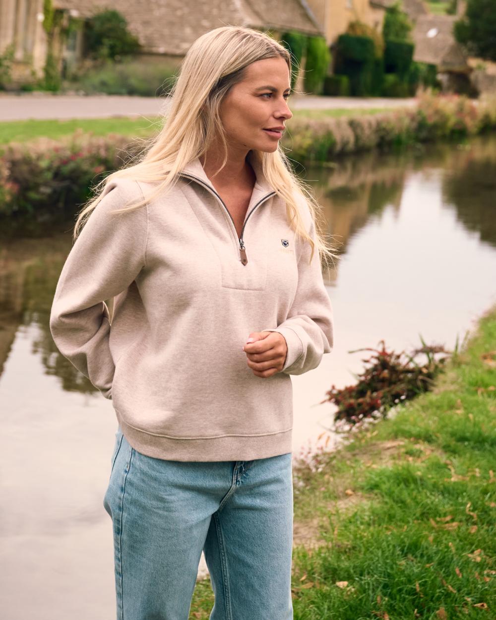 Bone coloured Dubarry Womens Castlemartyr Quarter Zip Sweatshirt on backyard background 