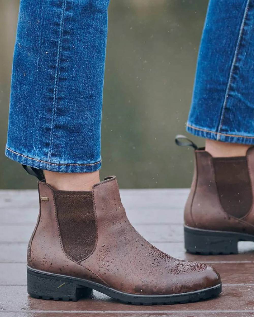 Old Rum coloured Dubarry Womens Waterford Chelsea Boots on wooden floor background 