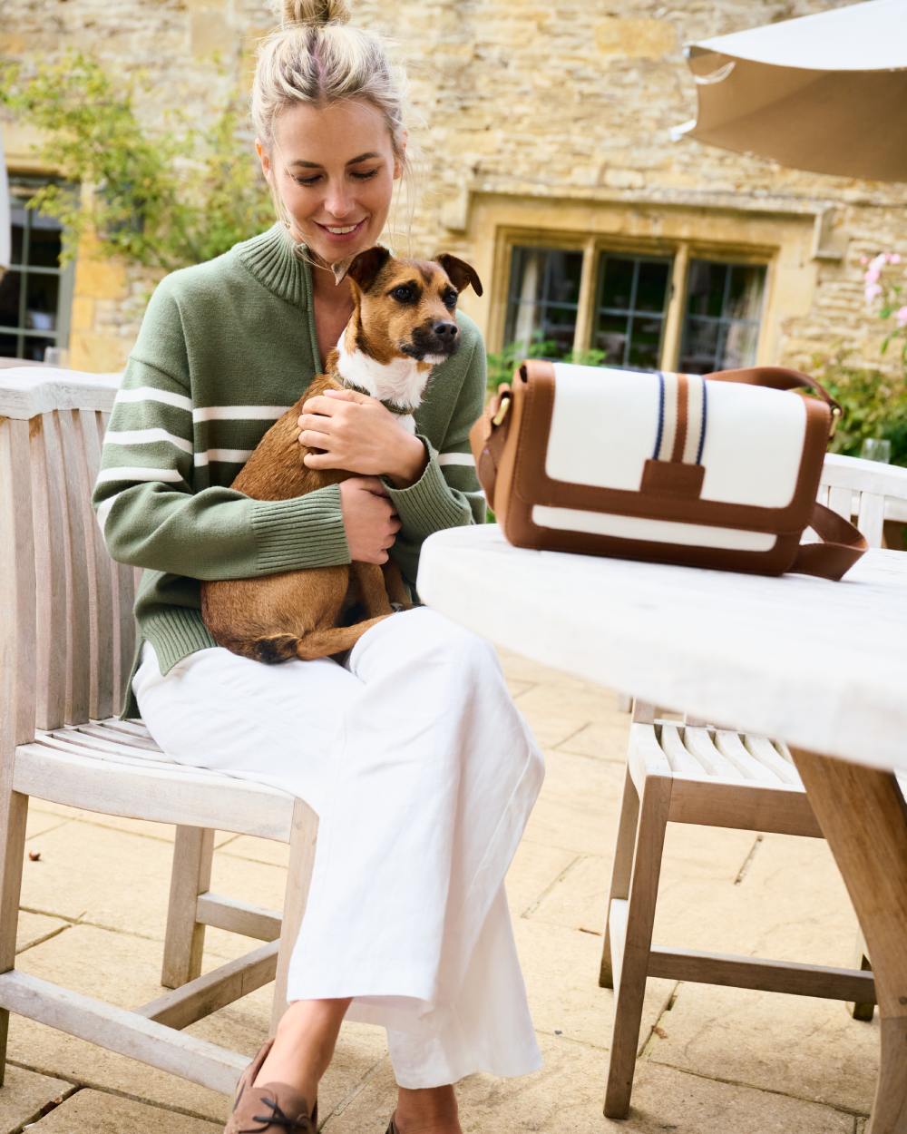 Caramel coloured Dubarry Hillsbrook Cross Body Bag on restaurant background 
