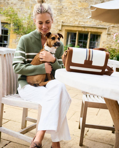 Caramel coloured Dubarry Hillsbrook Cross Body Bag on restaurant background 