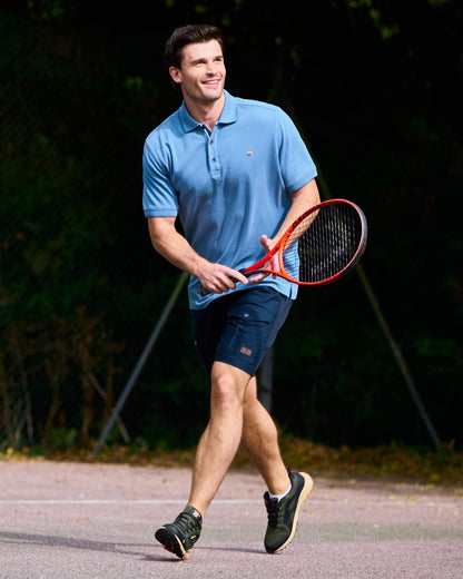 Indigo Coloured Dubarry Mens Morrison Polo Shirt on court background 