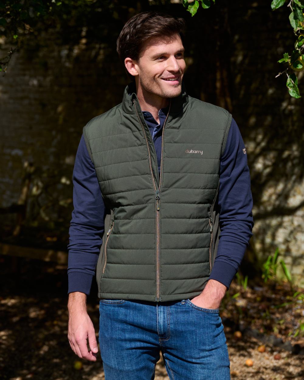 Olive coloured Dubarry Mens Solent Lightweight Hybrid Gilet on park background 