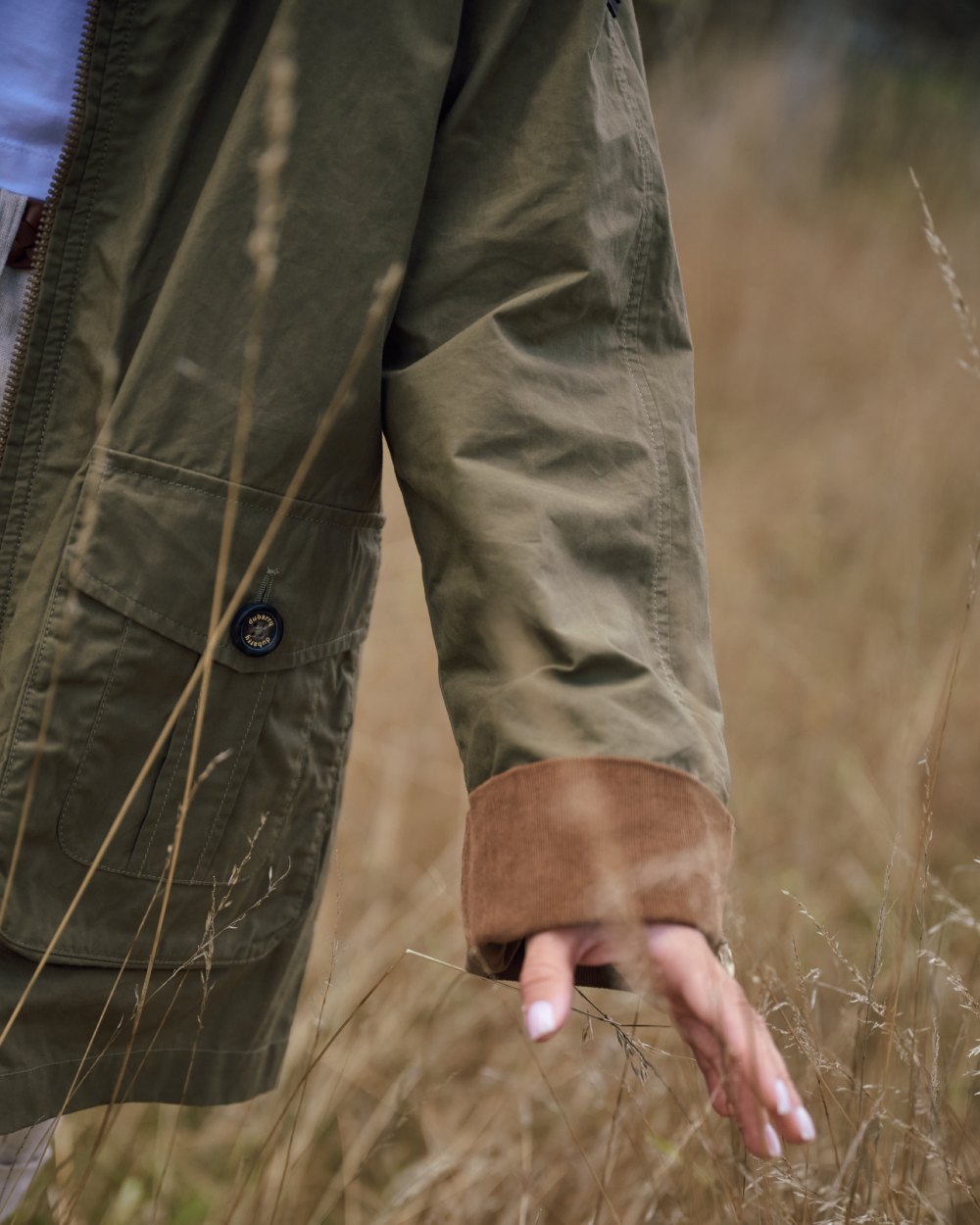 Dusky Green coloured Dubarry Womens Delaney Waxed Cotton Utility Jacket on blurry background 