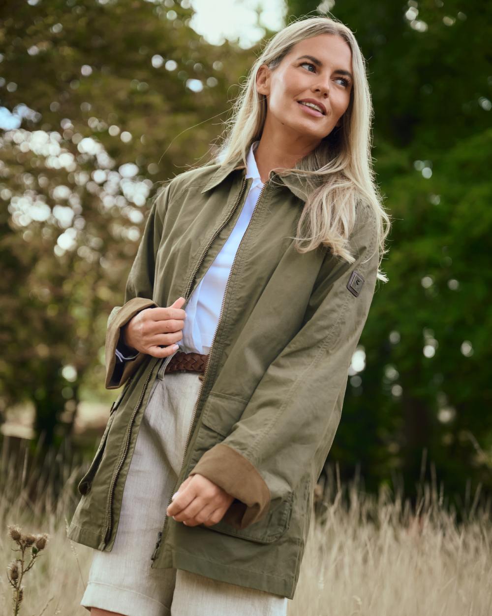Dusky Green coloured Dubarry Womens Delaney Waxed Cotton Utility Jacket on farm background 