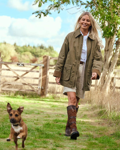 Dusky Green coloured Dubarry Womens Delaney Waxed Cotton Utility Jacket on farm background 