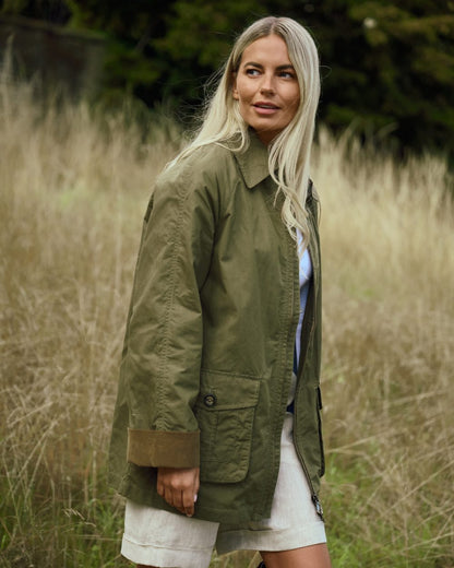 Dusky Green coloured Dubarry Womens Delaney Waxed Cotton Utility Jacket on blurry background 