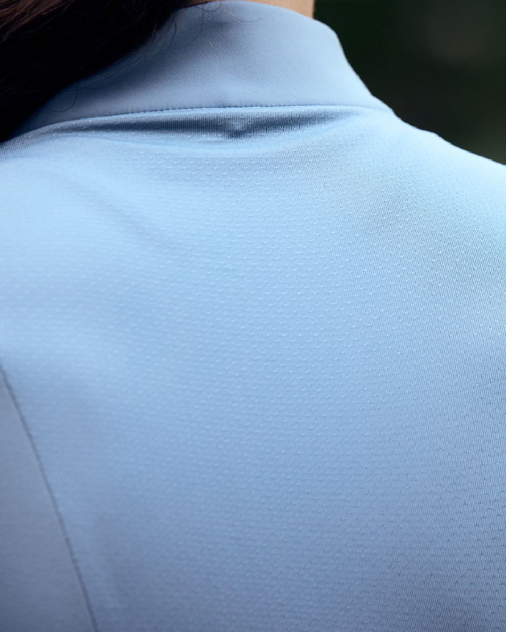 Blue Fog coloured Dublin Breathable Long Sleeve Riding Top on blurry background 