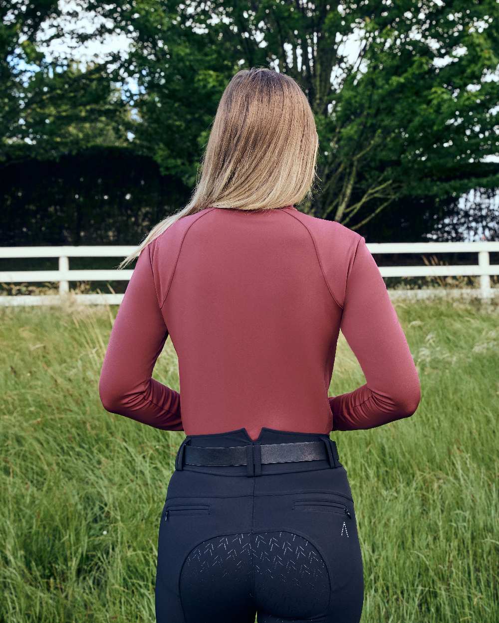 Cabernet coloured Dublin Womens Brushed Long Sleeve Riding Top on grassy background 