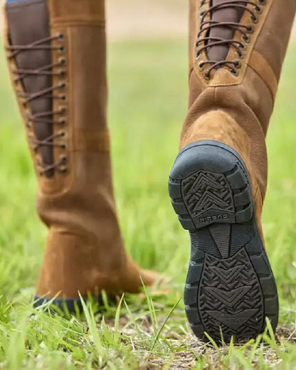 Chocolate coloured Dublin Danman Boots on grassy background 