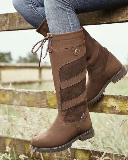 Chocolate coloured Dublin Kennet Boots on fences background 