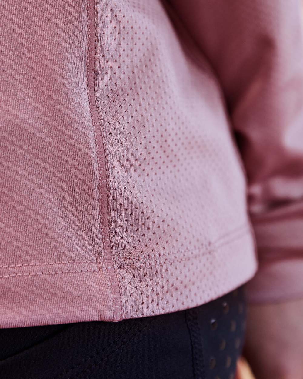 Dusty Rose coloured Dublin Kids Breathable Long Sleeve Riding Top on blurry background 