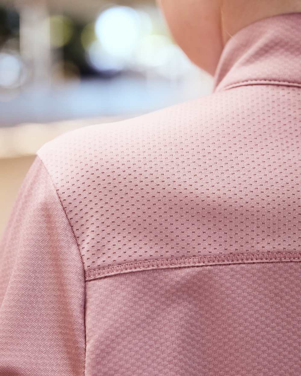 Dusty Rose coloured Dublin Kids Breathable Long Sleeve Riding Top on blurry background 