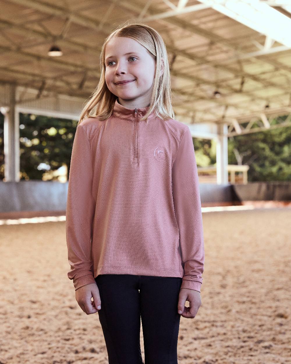 Dusty Rose coloured Dublin Kids Breathable Long Sleeve Riding Top on   sand background 
