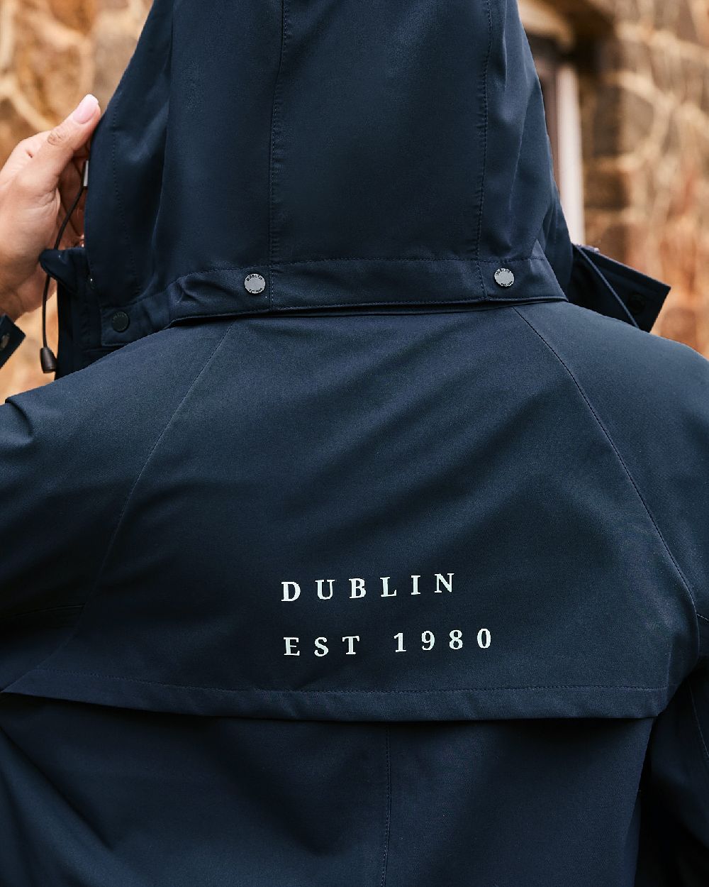 Sky Captain coloured Dublin Rowan Waterproof Riding Coat on blurry background 