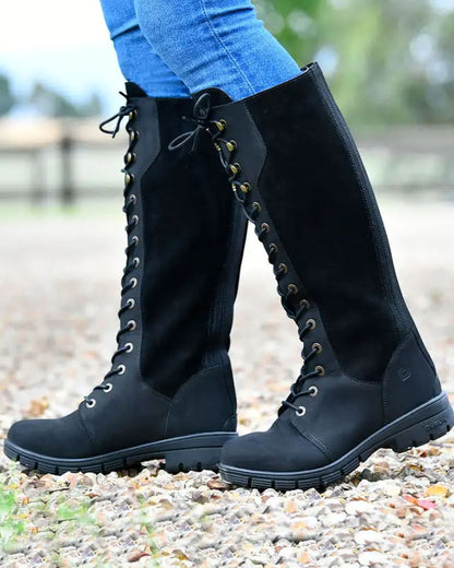 Black coloured Dublin Sloney Waterproof Boots on stone background 