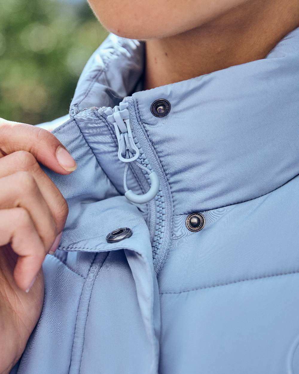 Blue Fog coloured Dublin Womens Puffer Body Warmer on blurry background 