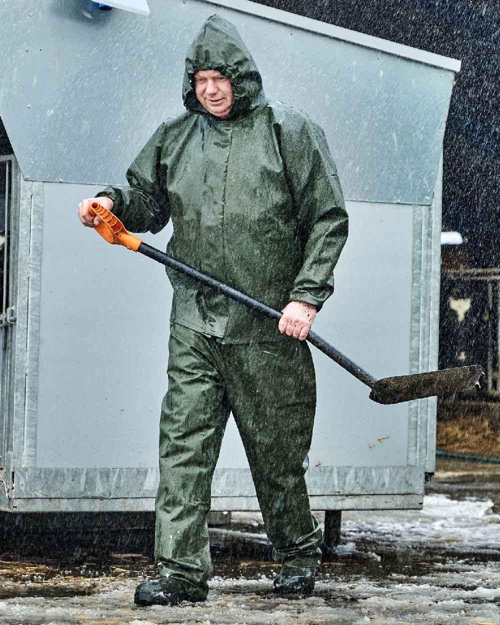 Olive Coloured Elka Light Waist Trousers on construction background 