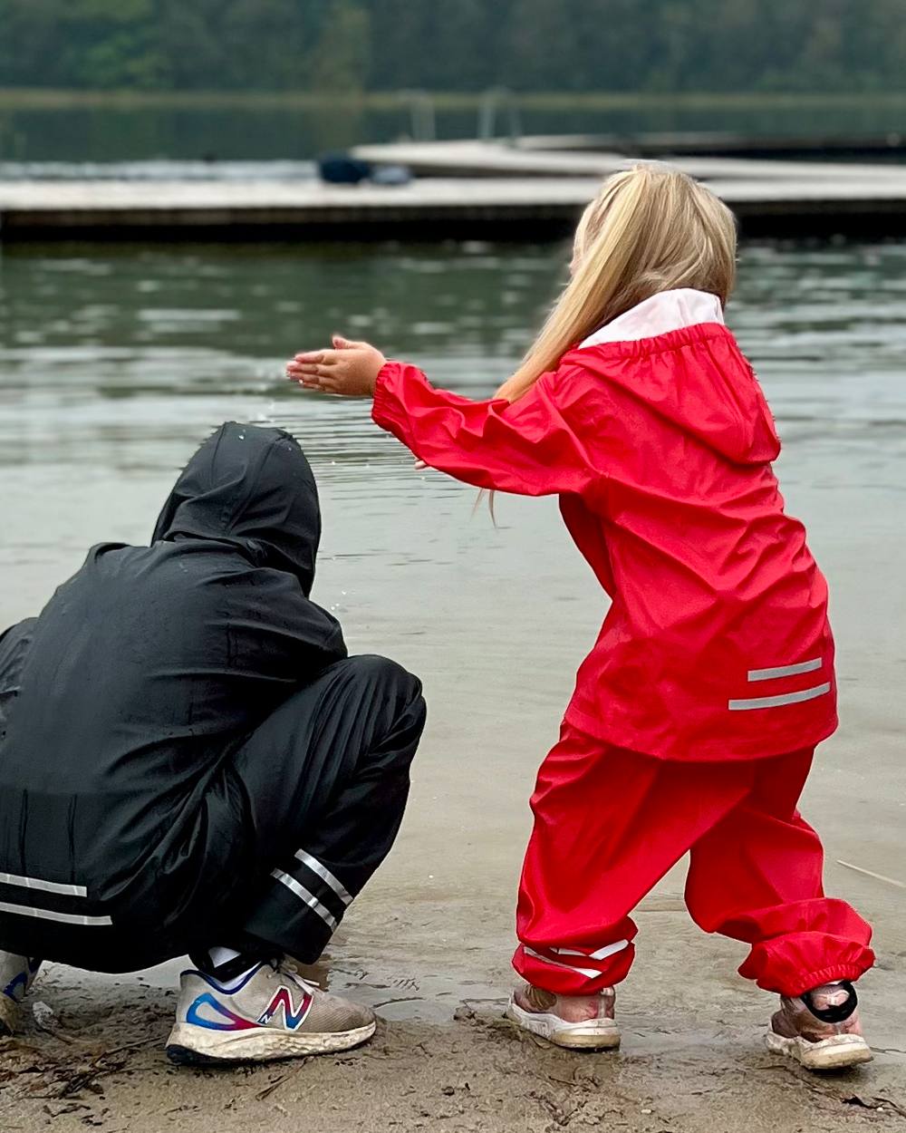 Red Coloured Elka Childrens Rain Set on lake background 