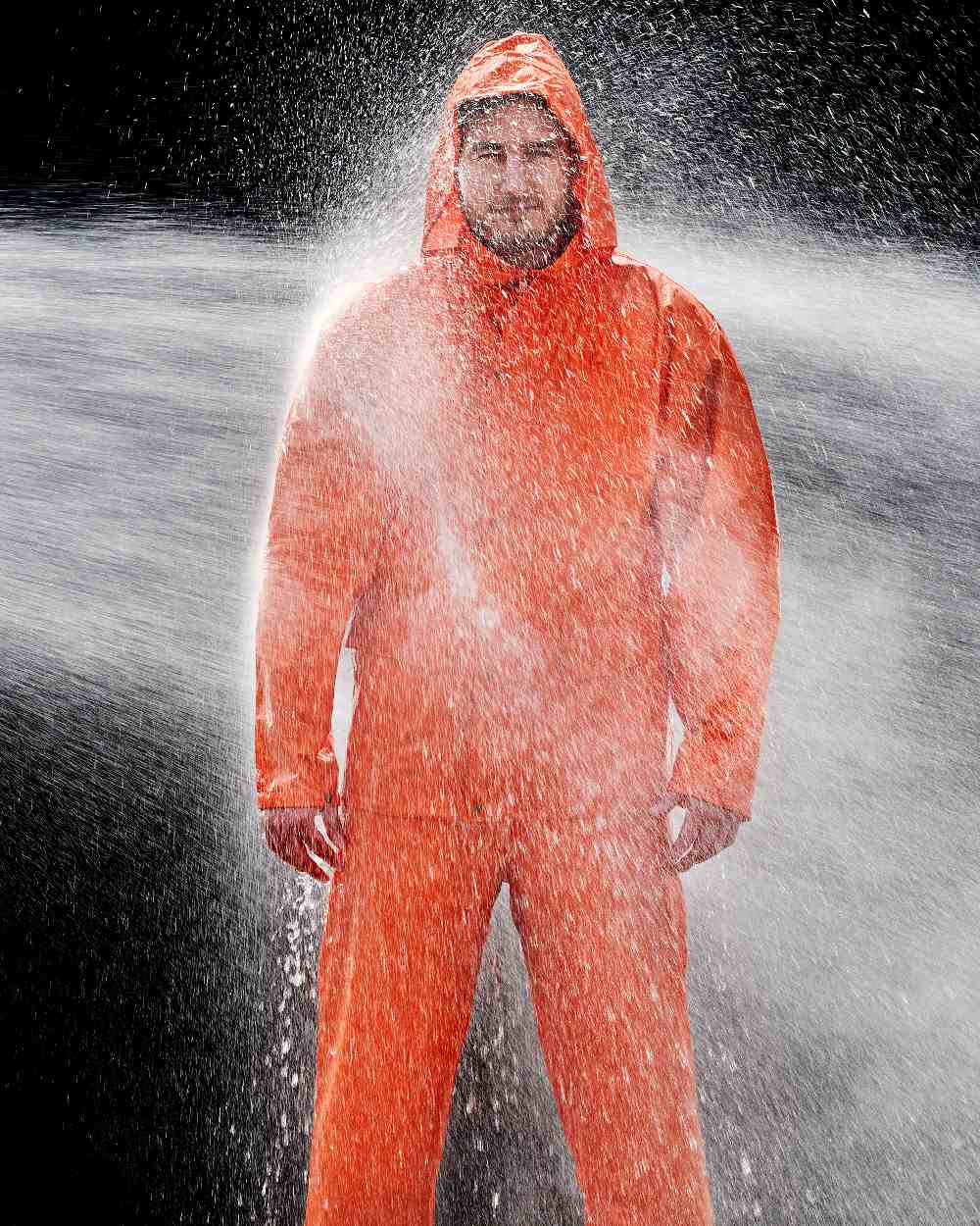 Orange Coloured Elka Mens Dry Zone PU Rain Trousers on water background 
