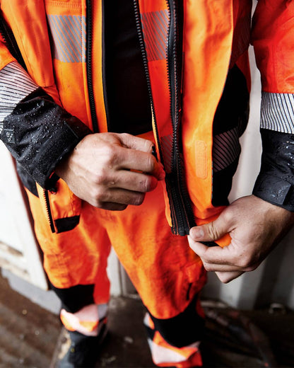 Fluorescent Orange Black Coloured Elka Mens Visible Xtreme Stretch Jacket on blurry background 