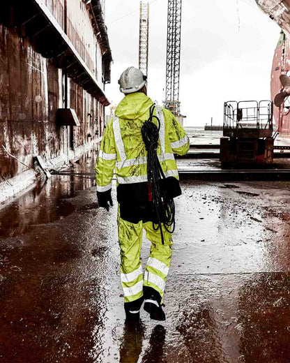 Fluorescent Yellow Black Coloured Elka Mens Visible Xtreme Stretch Jacket on construction background 