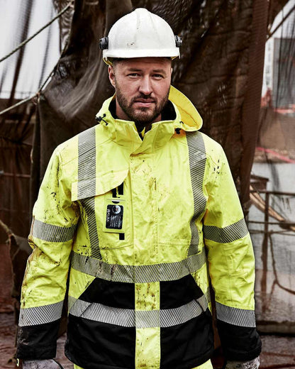 Fluorescent Yellow Black Coloured Elka Mens Visible Xtreme Stretch Jacket on construction background 
