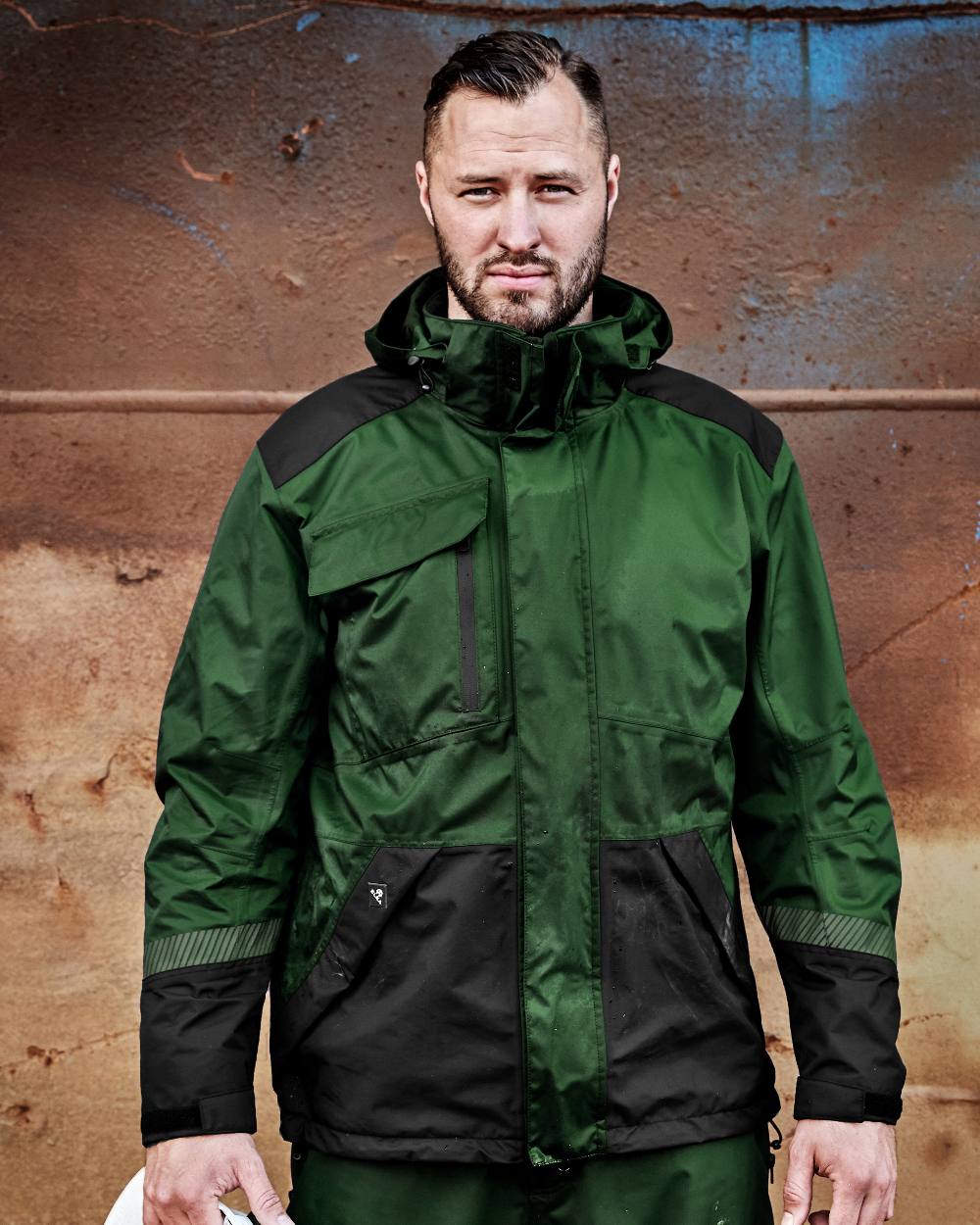 Green Black Coloured Elka Mens Working Xtreme Stretch Jacket on construction background 