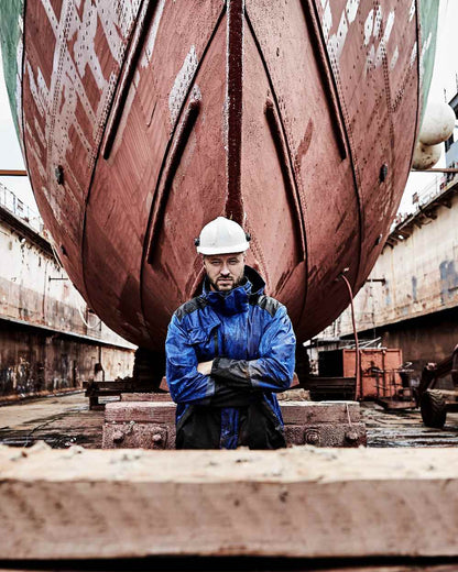 Royal Blue Black Coloured Elka Mens Working Xtreme Stretch Jacket on construction background 