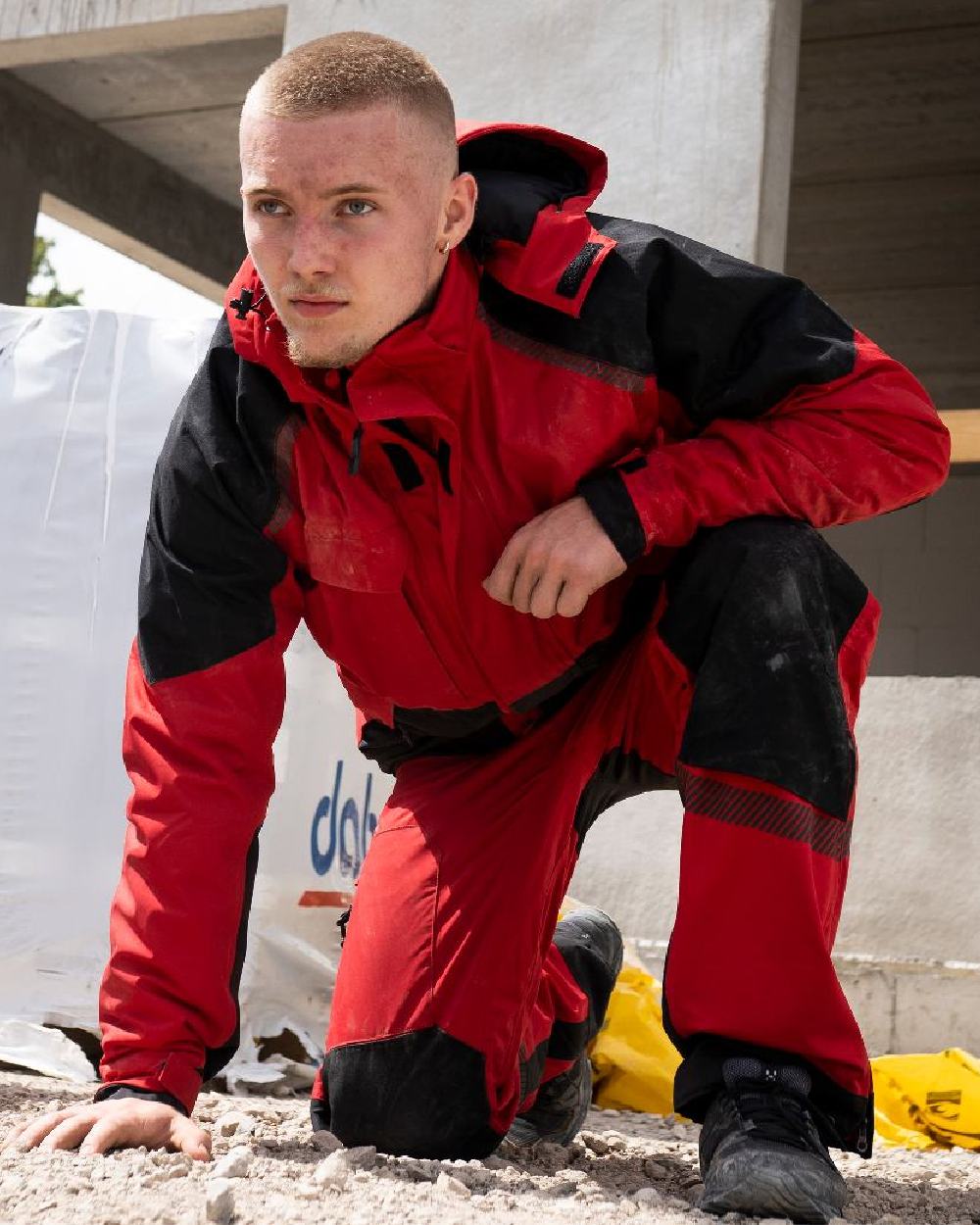Red Black Coloured Elka Mens Working Xtreme Stretch Waist Trousers on building background 