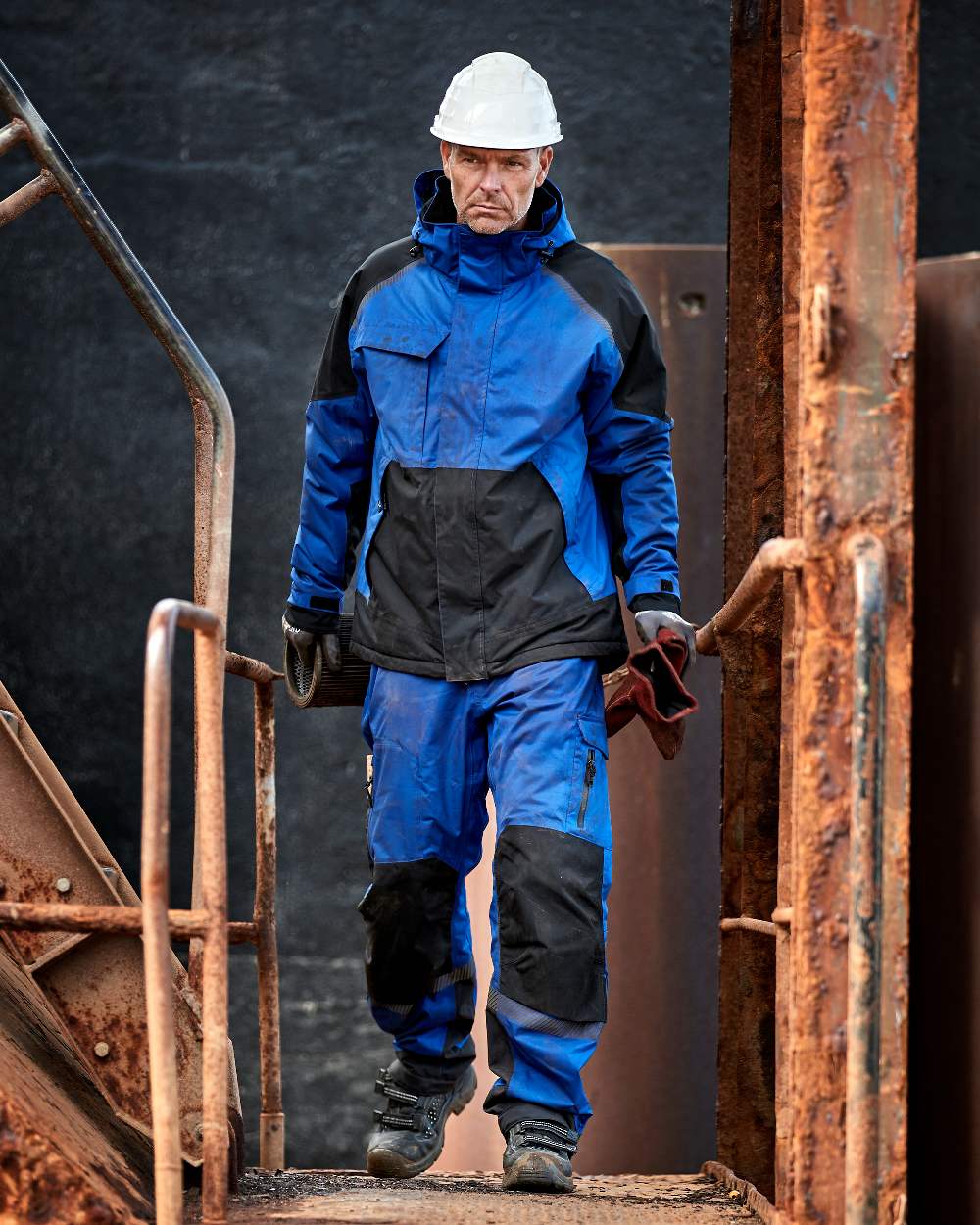Royal Blue Black Coloured Elka Mens Working Xtreme Stretch Winter Jacket on construction background 