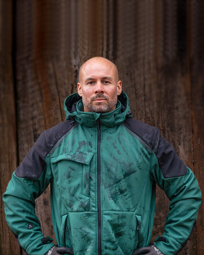 Green Black Coloured Elka Mens Working Xtreme Winter Softshell Jacket on blurry background 