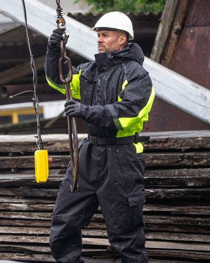 Black Fluorescent Yellow Coloured Elka Mens Working Xtreme Winter Thermal Coverall With Recycled Padding on construction background 