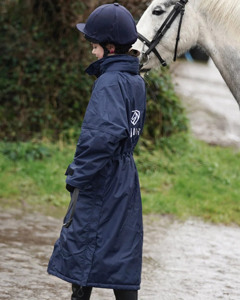 Navy coloured Equidry Children Pro Ride Evolution Thin Fleece With Stowaway Hood on outdoor background 