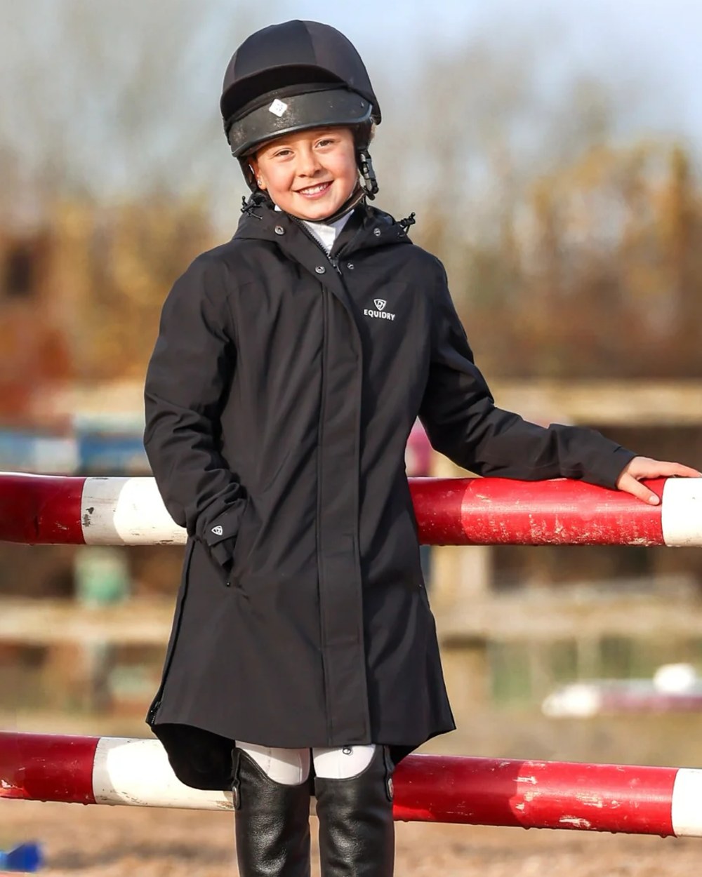 Black coloured Equidry Childrens Bronte Riding Coat on field background 