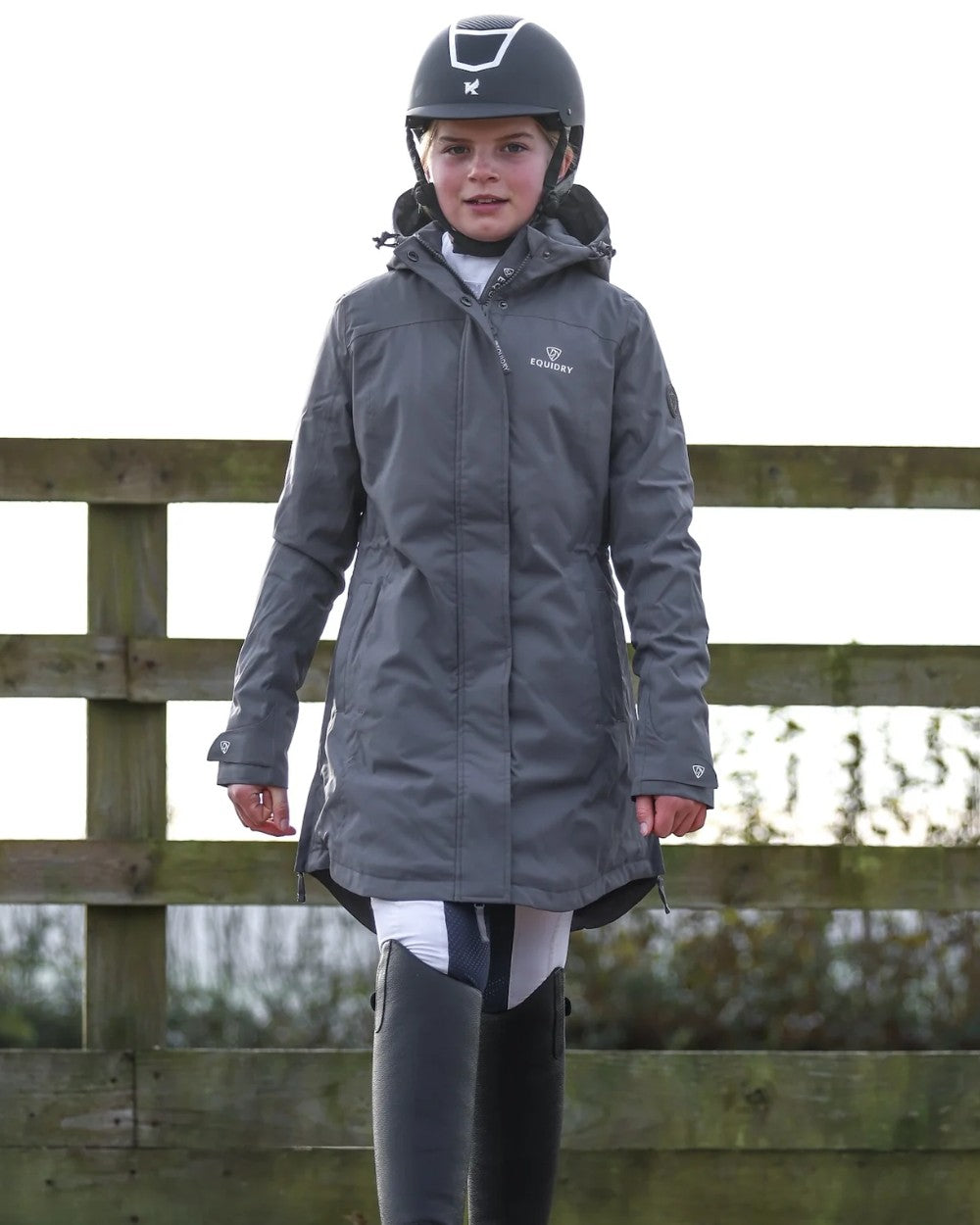 Charcoal coloured Equidry Childrens Bronte Riding Coat on outdoor background 