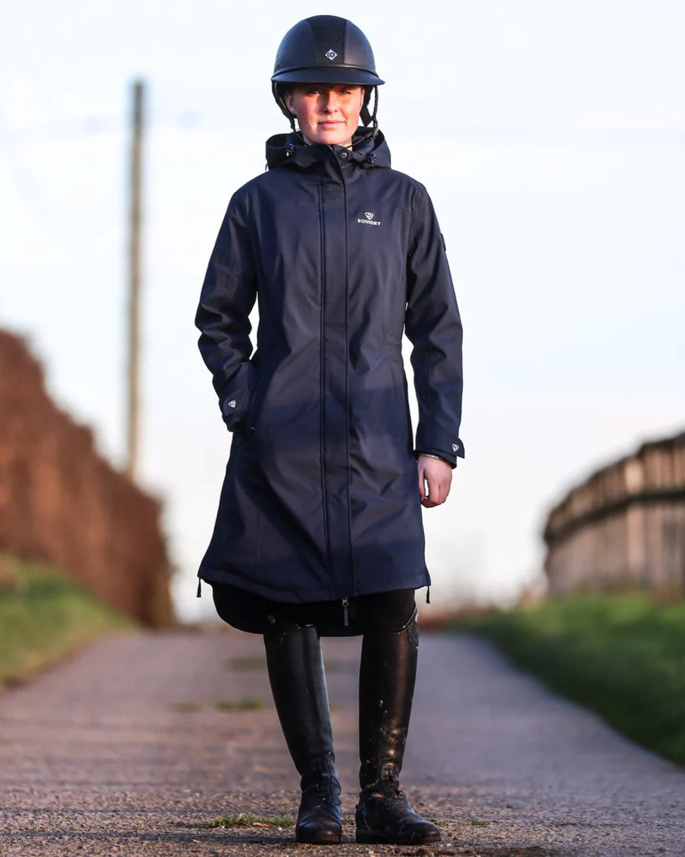 Navy coloured Equidry Childrens Bronte Riding Coat on street background 