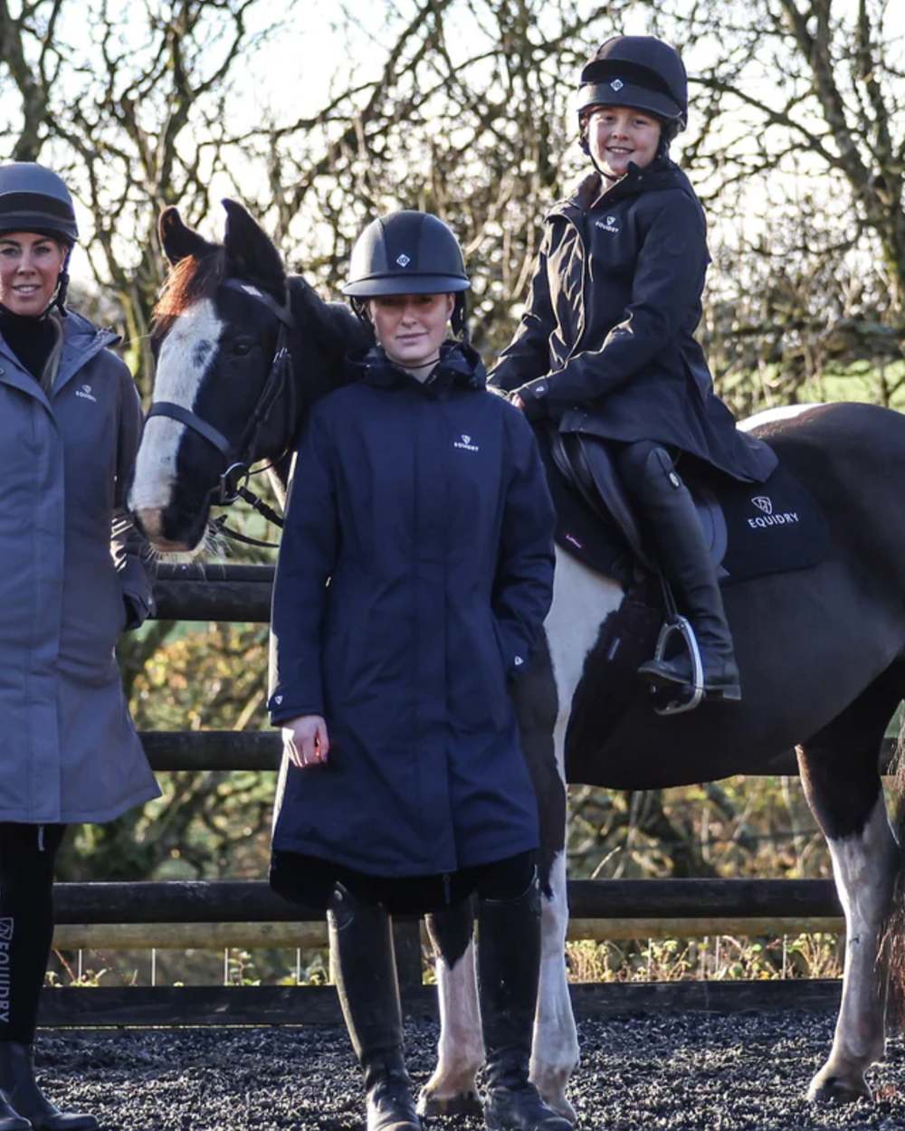 Navy coloured Equidry Childrens Bronte Riding Coat on outdoor background 