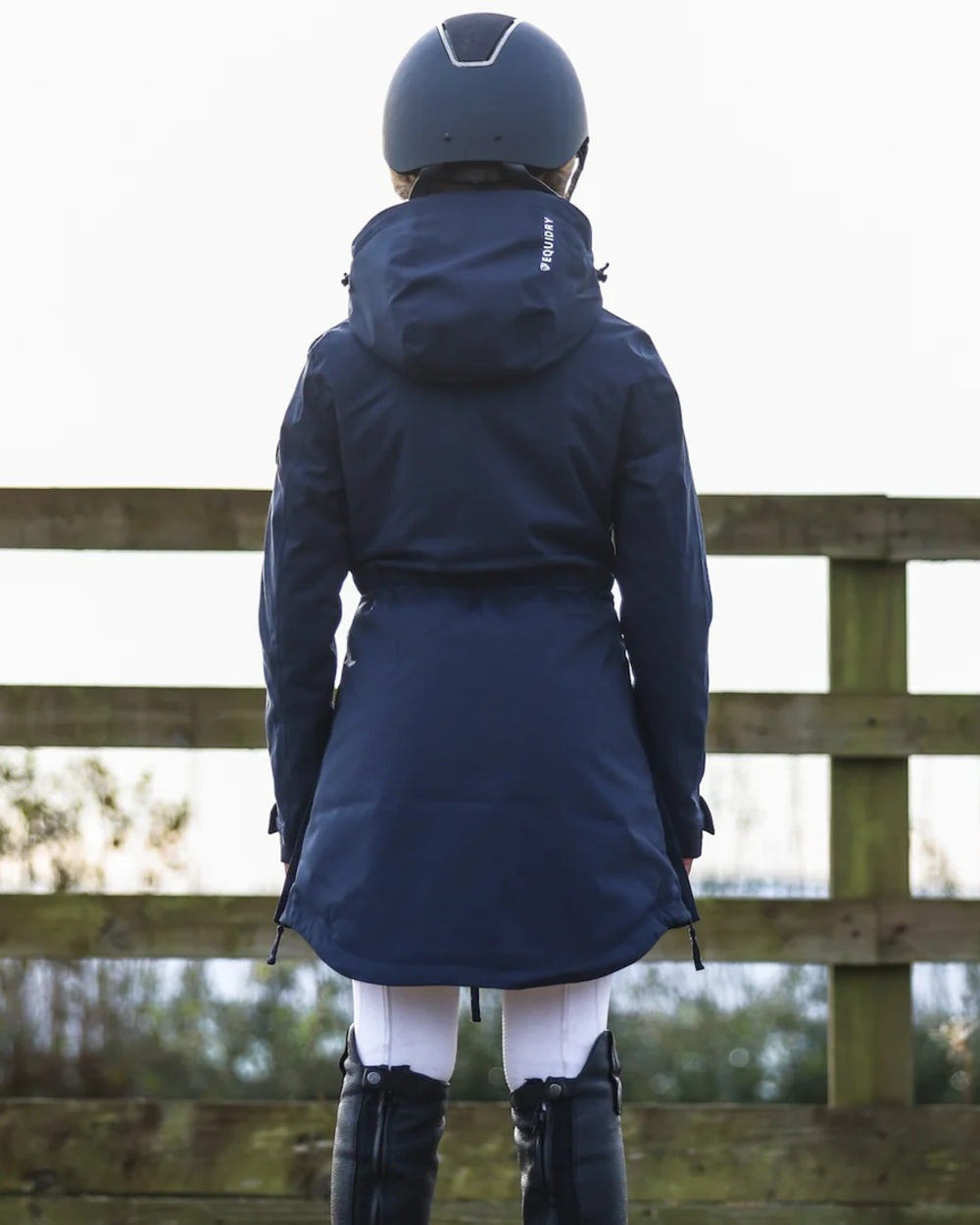 Navy coloured Equidry Childrens Bronte Riding Coat on outdoor background 