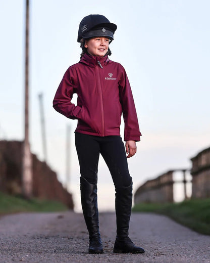 Plum coloured Equidry Childrens Nimbus Pack Away Jacket With Stowaway Hood on outdoor background 