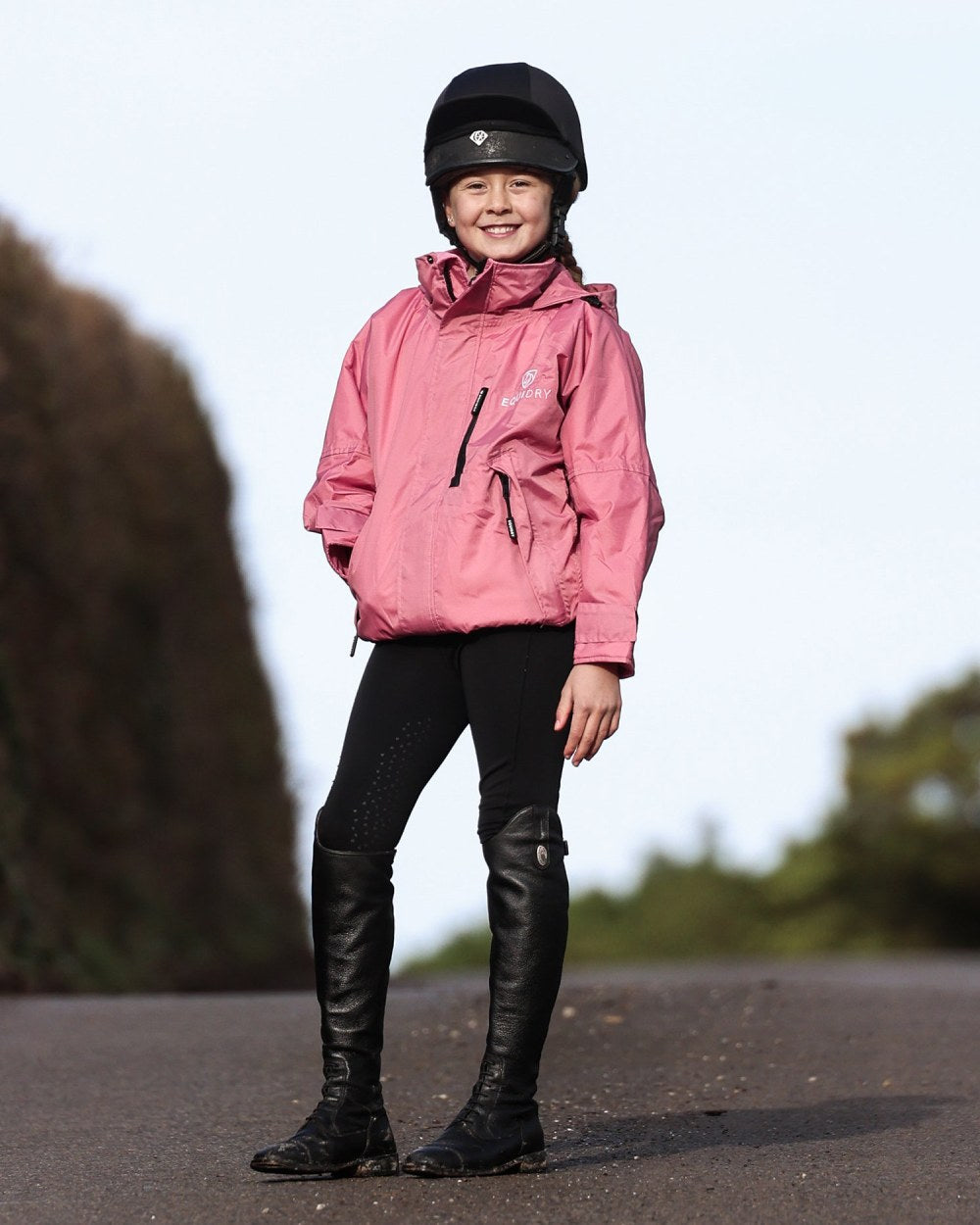 Dusky Pink coloured Equidry Childrens Shortie Jacket on street background 
