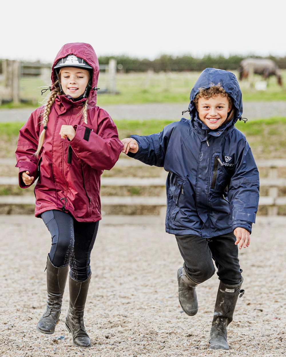 Navy coloured Equidry Childrens Shortie Jacket on street background 
