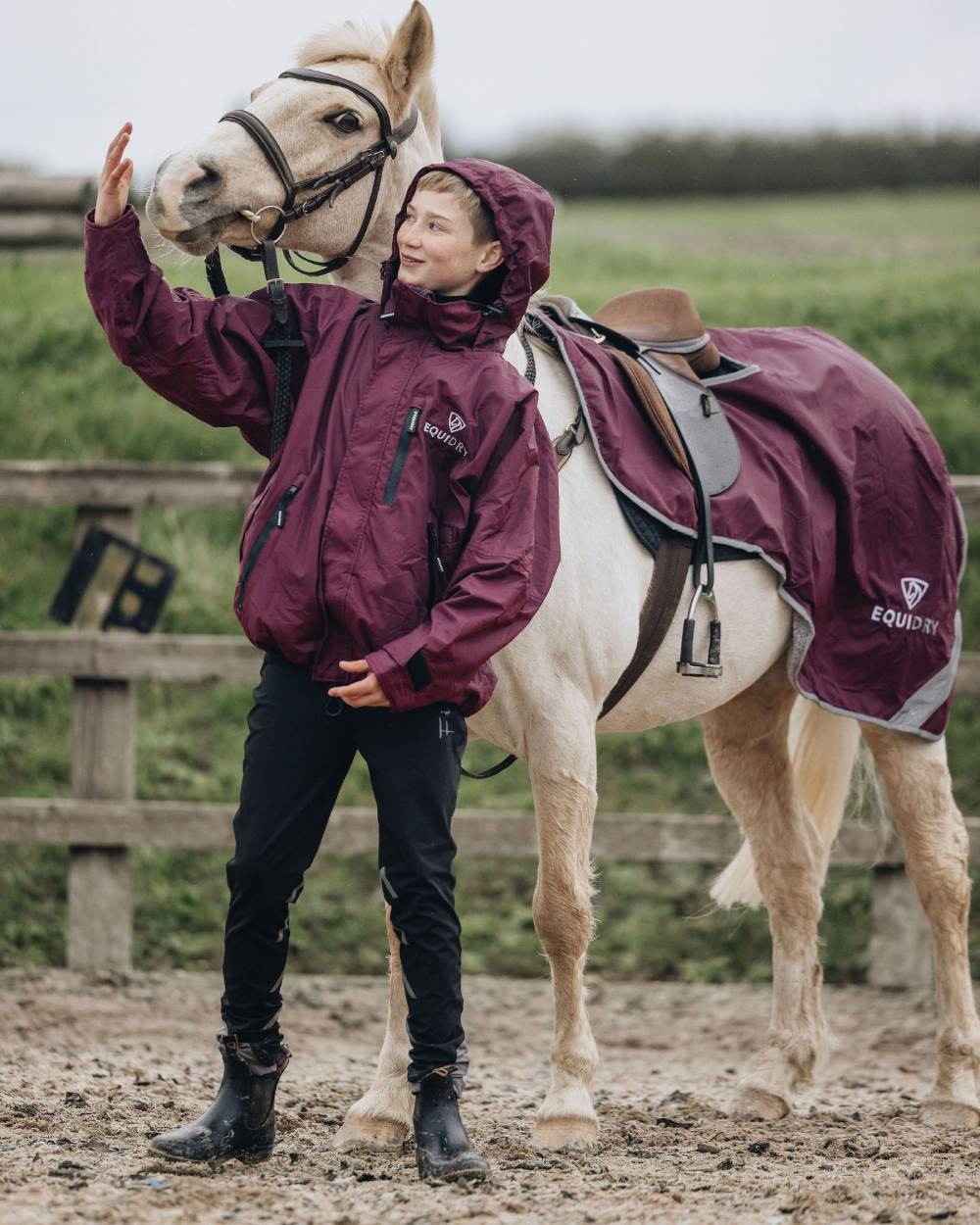 Plum coloured Equidry Childrens Shortie Jacket on street background 