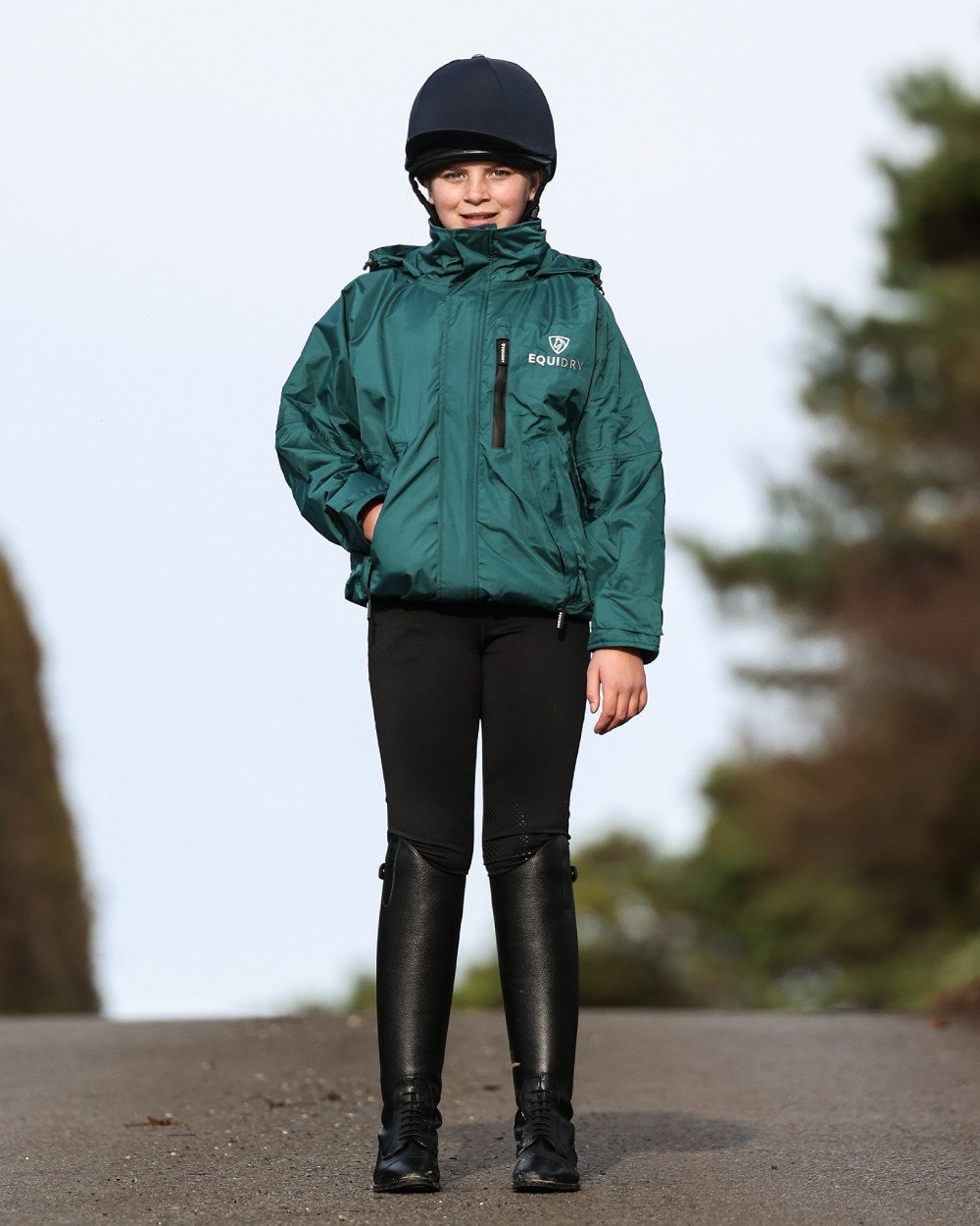 Teal coloured Equidry Childrens Shortie Jacket on street background 