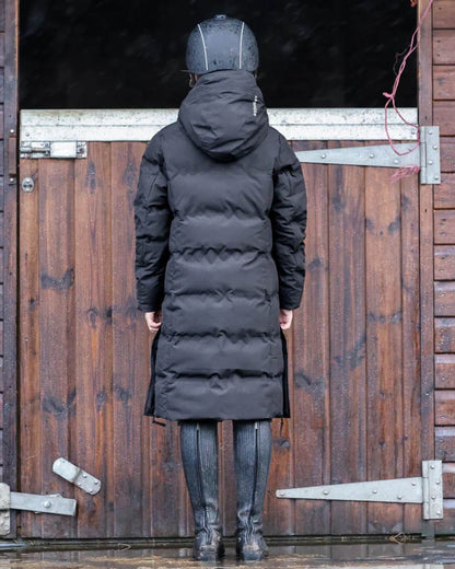 Black coloured Equidry Childrens Thora Waterproof Riding Puffer Jacket With Hood on stable background 