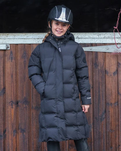 Black coloured Equidry Childrens Thora Waterproof Riding Puffer Jacket With Hood on stable background 