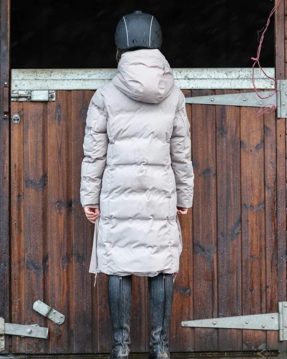 Taupe coloured Equidry Childrens Thora Waterproof Riding Puffer Jacket With Hood on stable background 
