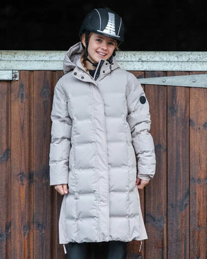 Taupe coloured Equidry Childrens Thora Waterproof Riding Puffer Jacket With Hood on stable background 