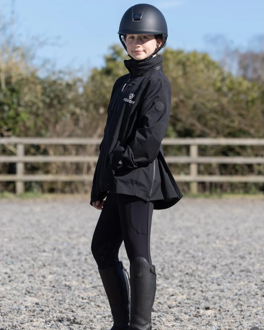 Black coloured Equidry Childrens Varsha Waterproof Jacket on farm background 